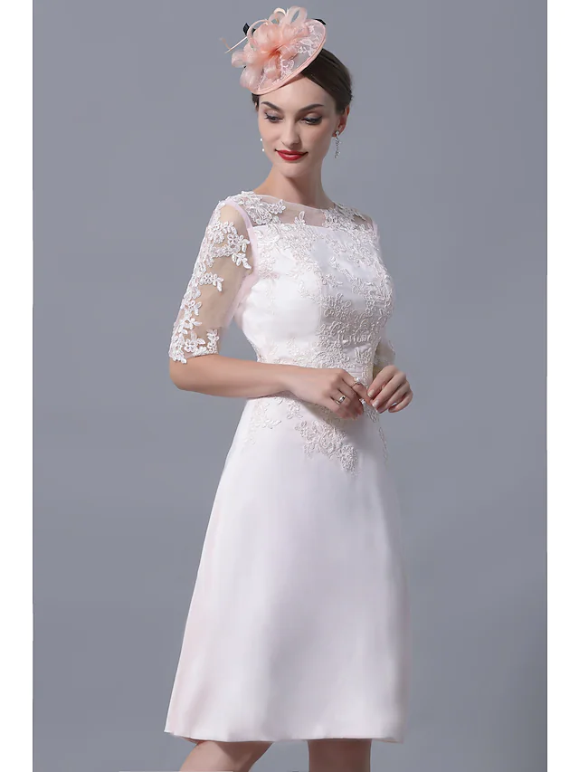 Detail of the jewel neckline and short sleeve of the elegant dress.