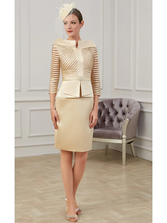Full view of a woman wearing a knee-length Mother of the Bride dress.