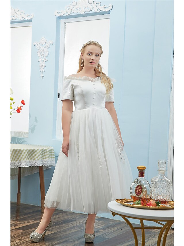 Close-up of the off-shoulder neckline and short sleeves on the ball gown.