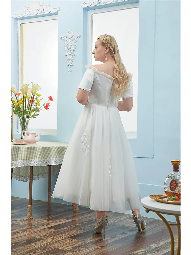 Back view of the plus size off-shoulder ball gown, showcasing its elegant silhouette.