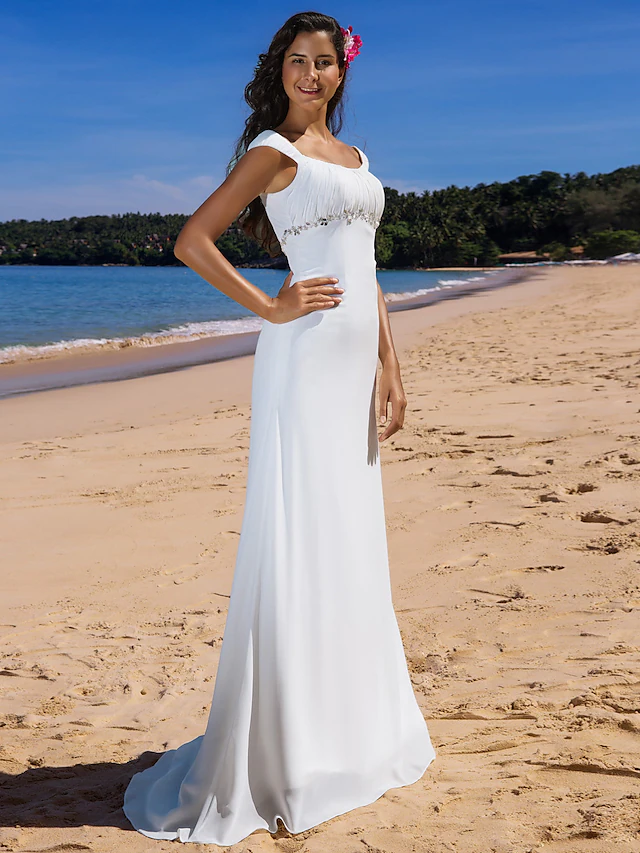 Close-up of scoop neck and cap sleeve details on a wedding dress.
