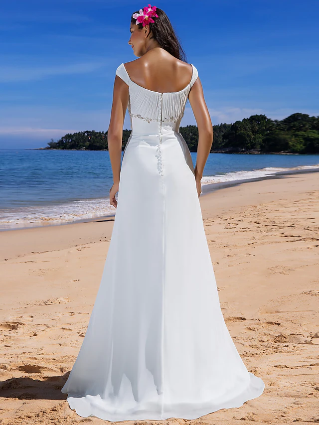 Side profile of a chiffon wedding dress with elegant draping.