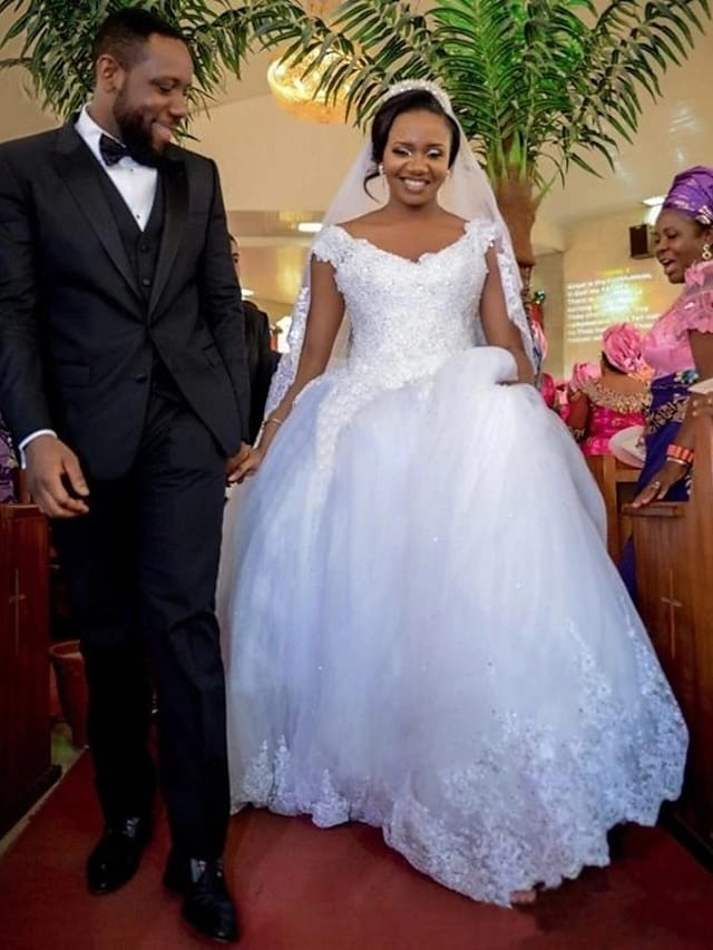 Back view of the plus size wedding dress showcasing the beautiful back design and cathedral train.