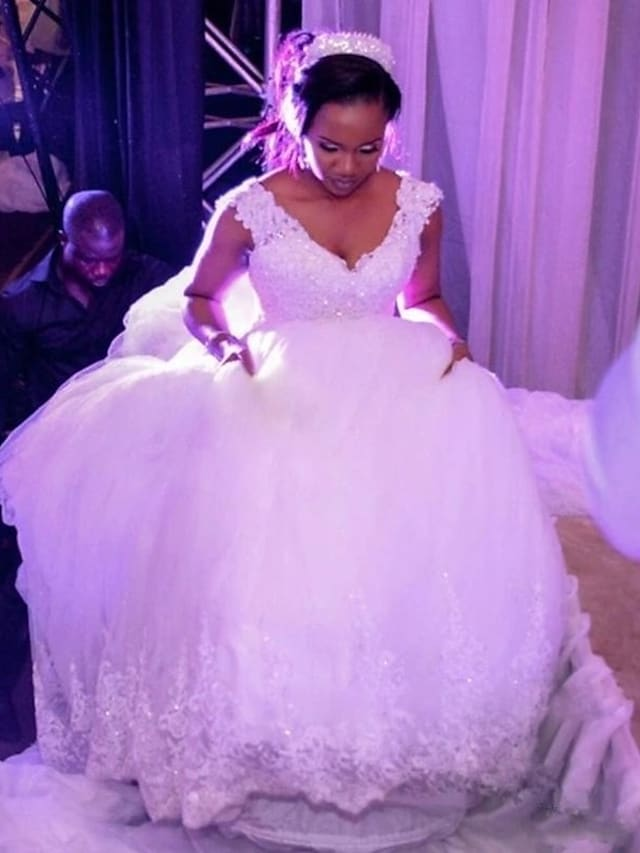 Side view of the ball gown wedding dress, highlighting the full skirt and lace details.