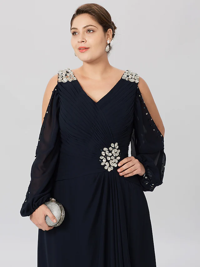 Close-up of V-neckline and criss-cross crystal detail on a formal dress.