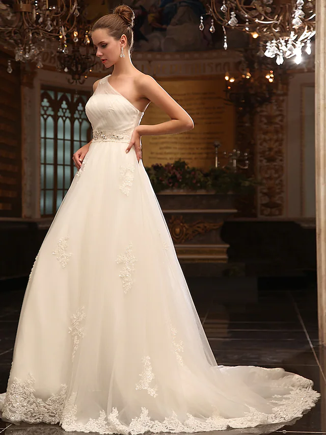 Back view of the wedding gown, highlighting the flowing court train.