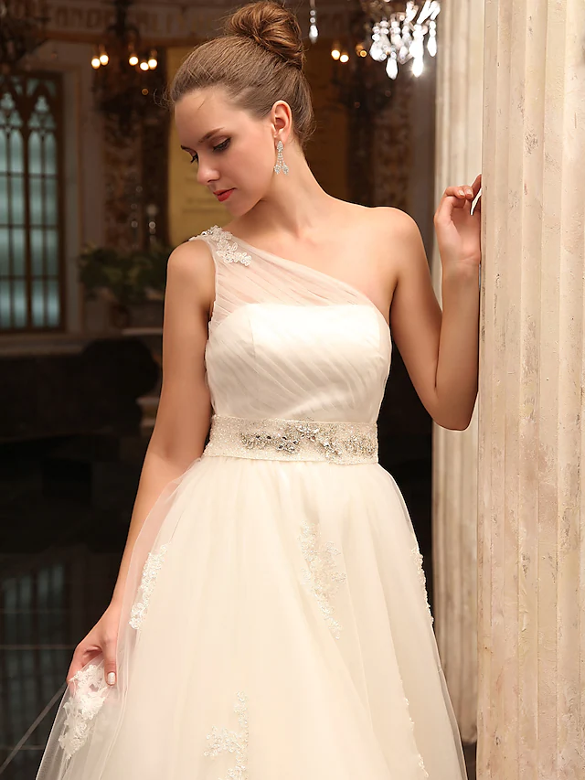 Full length view of the sleeveless A-Line bridal gown.