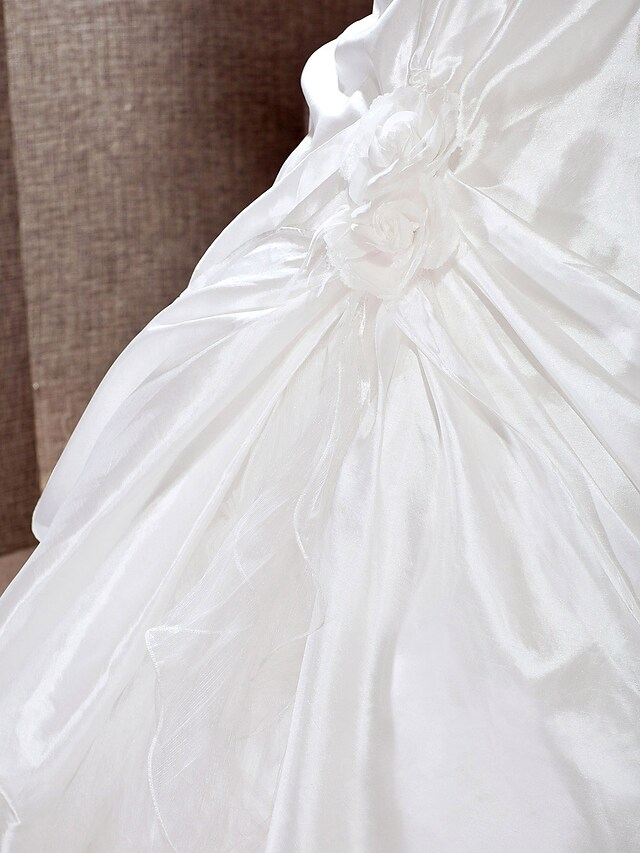 Flowing cathedral train of a princess wedding gown.