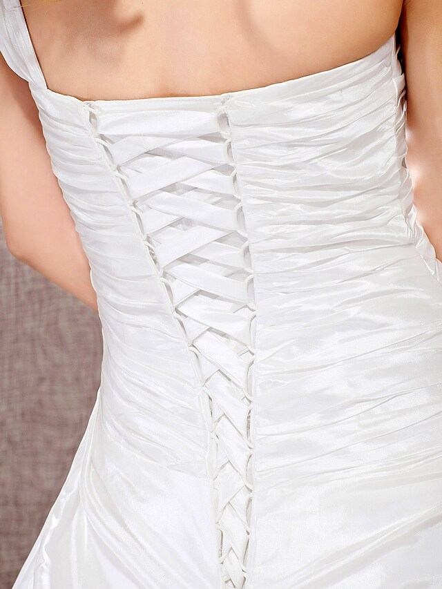 Bride posing in a classic A-line wedding dress.