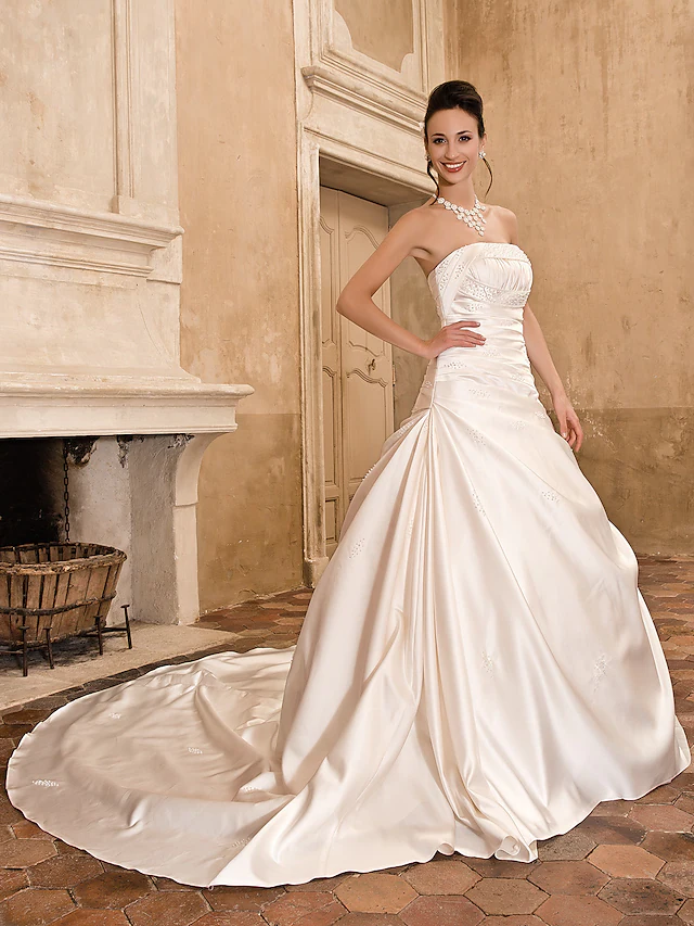 Back view of a strapless satin A-line wedding dress with chapel train.