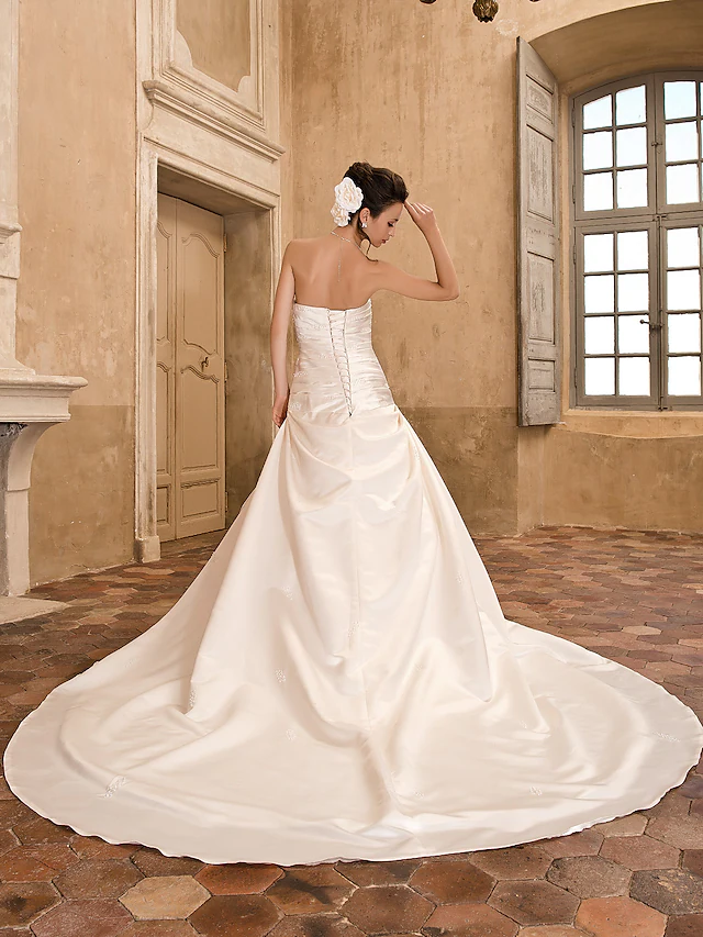 Close-up of the satin fabric and bodice details of a wedding dress.