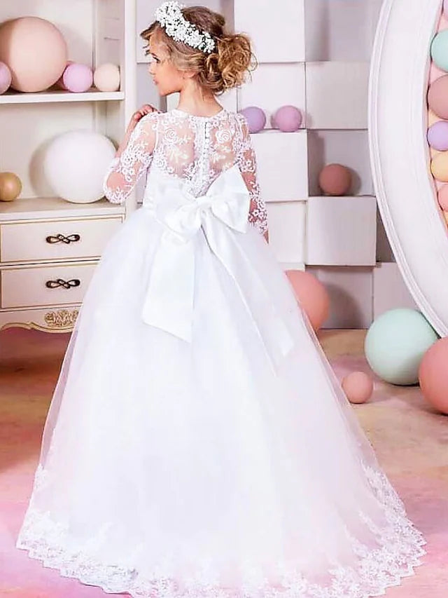 Side view of a young girl wearing the elegant floor length flower girl dress.