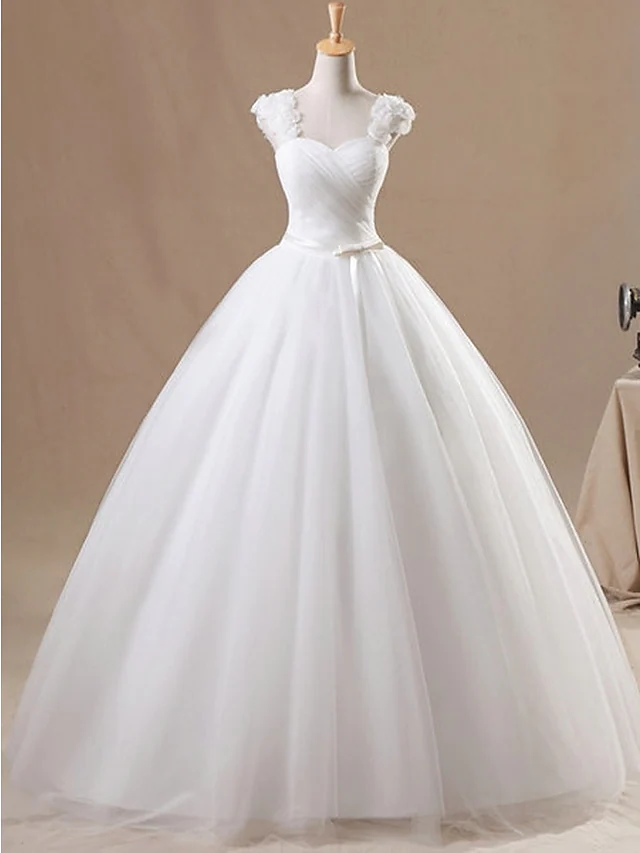 Elegant ball gown wedding dress with jewel neck and ruched appliques.