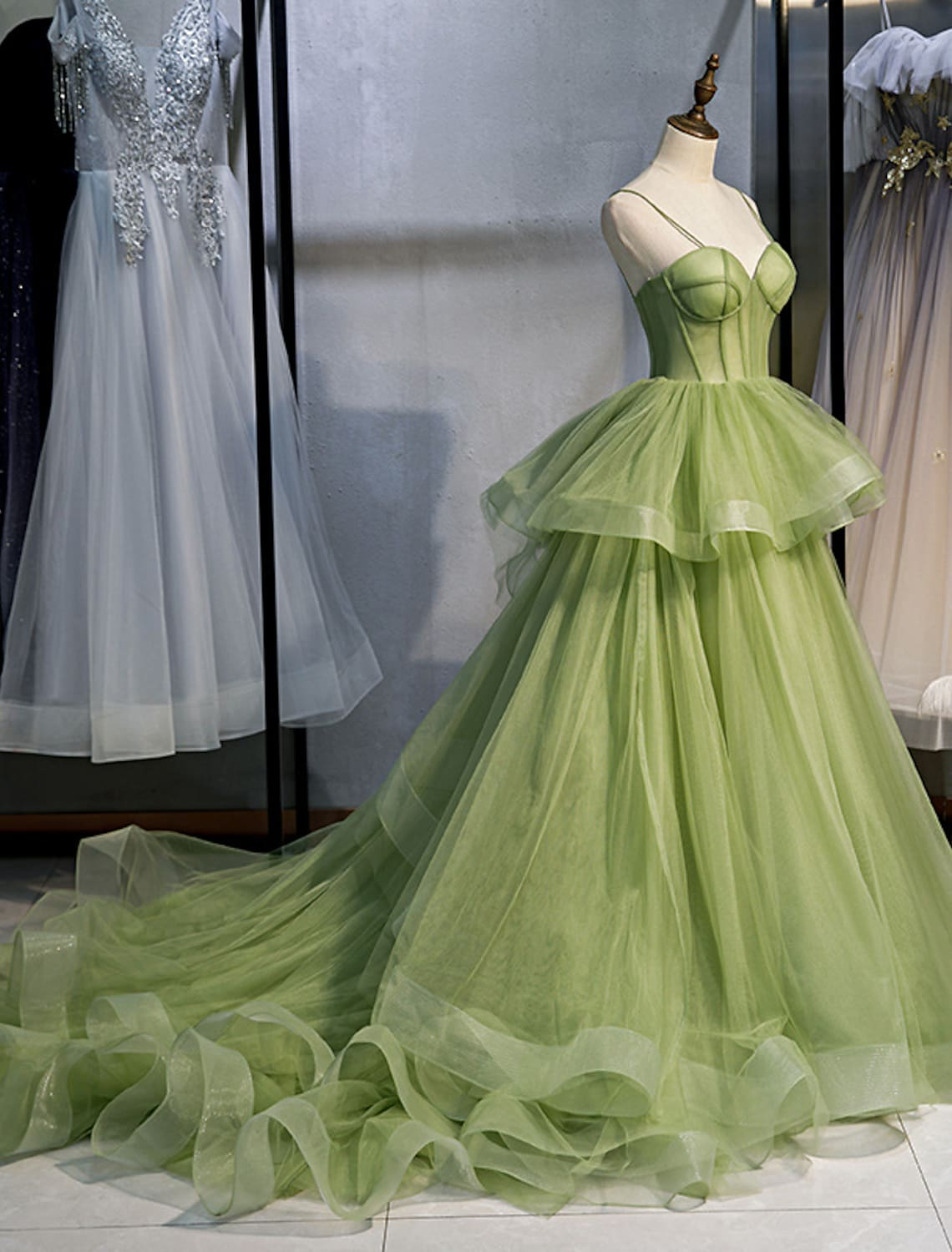 Side view of a light blue Quinceanera ball gown featuring a court train.