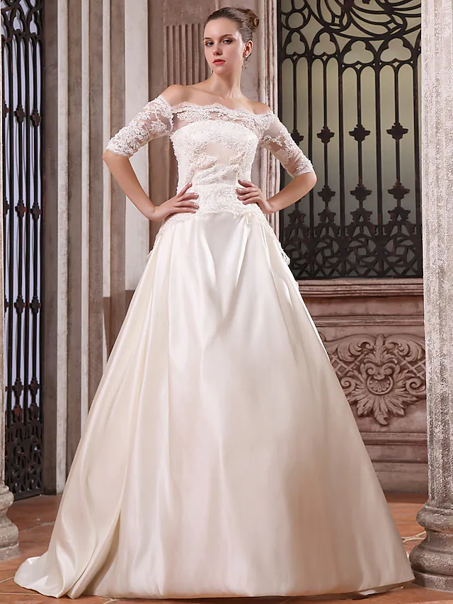 Elegant white satin ball gown wedding dress with scalloped off-shoulder neckline and half sleeves, front view.
