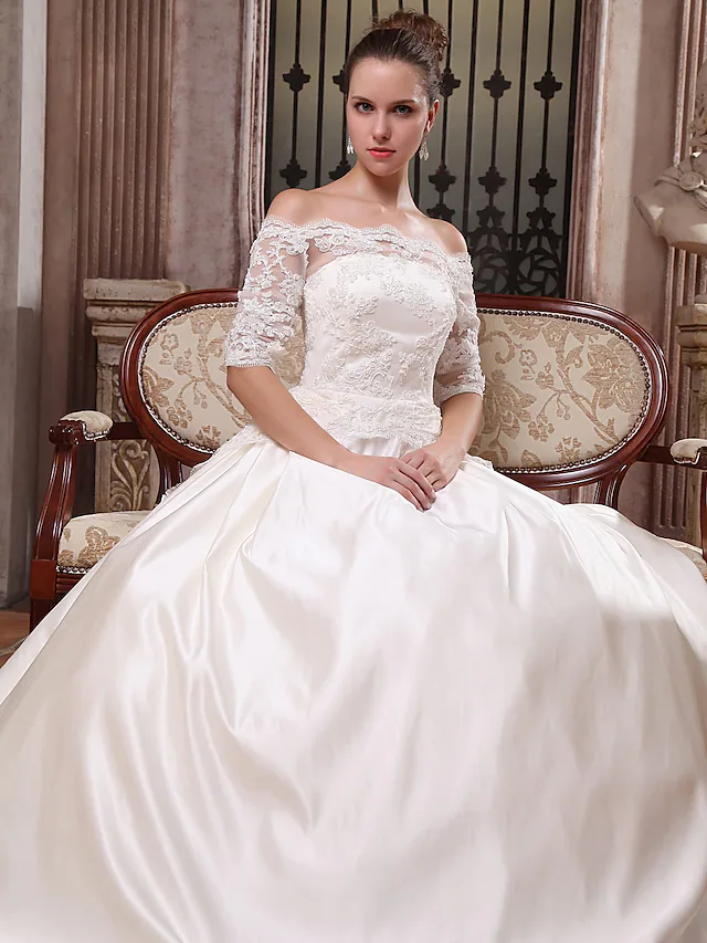 Bride wearing the white satin ball gown wedding dress, showcasing its full silhouette.