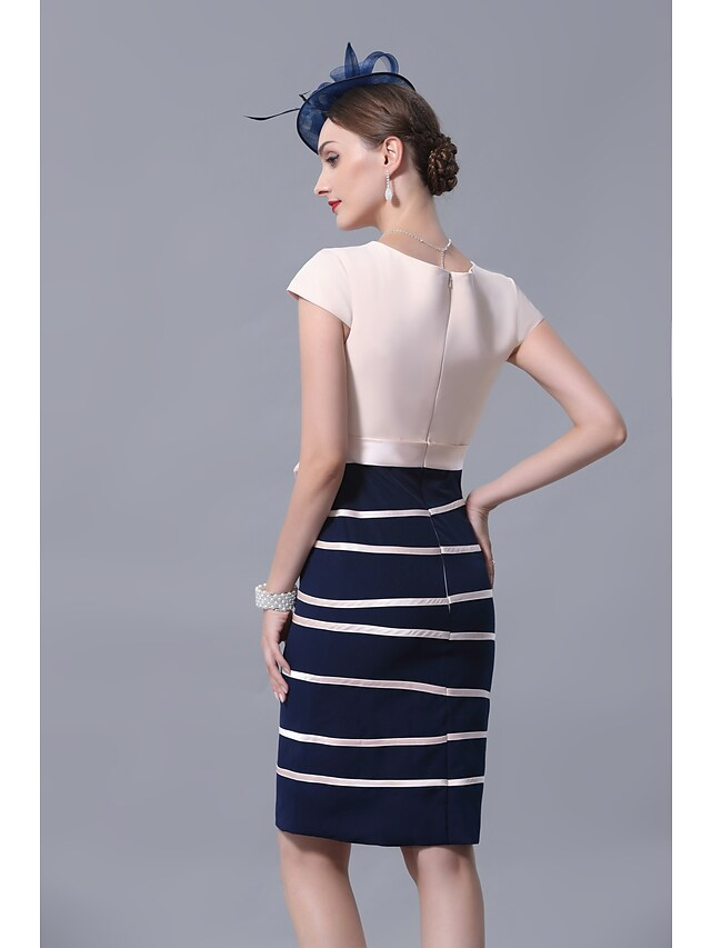 Back view of a satin knee-length dress with a sash and ribbon bow.