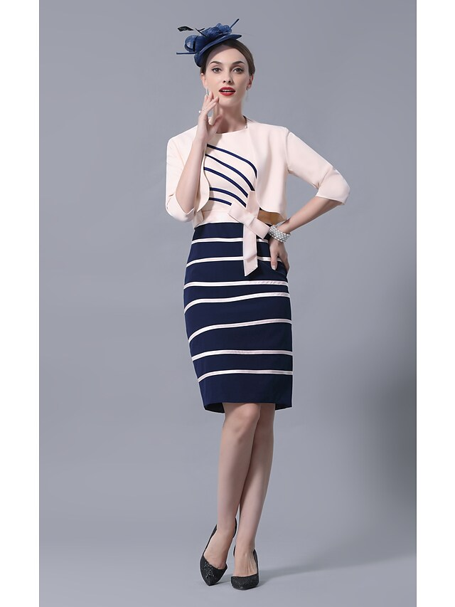 Close-up of the jewel neckline and 3/4 sleeve on a satin dress.