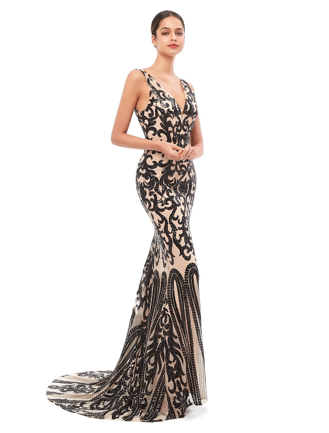 Woman in an elegant sequin tulle mermaid V-neck evening gown.