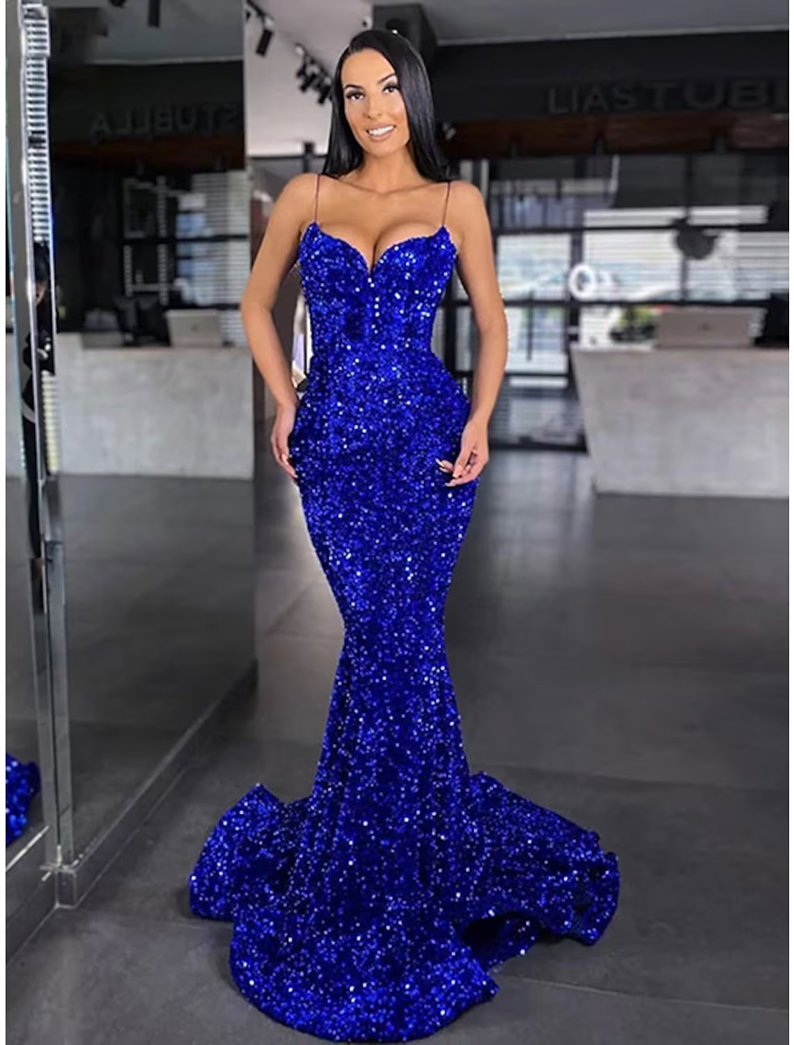 Elegant sequined mermaid trumpet maxi prom dress with spaghetti straps and a backless design.