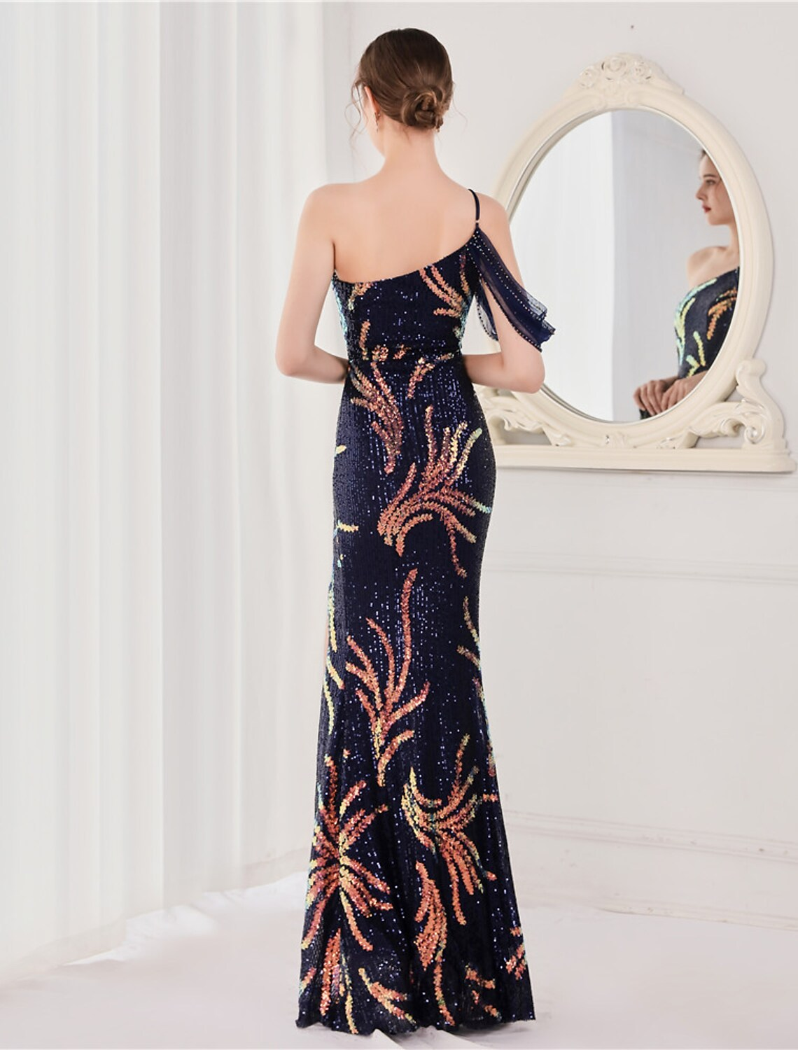 Back view of the sequined mermaid trumpet gown showing V-back and slit.
