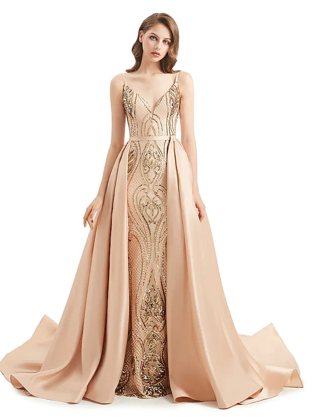 Woman wearing a sequined mermaid trumpet evening gown with a V-neck.