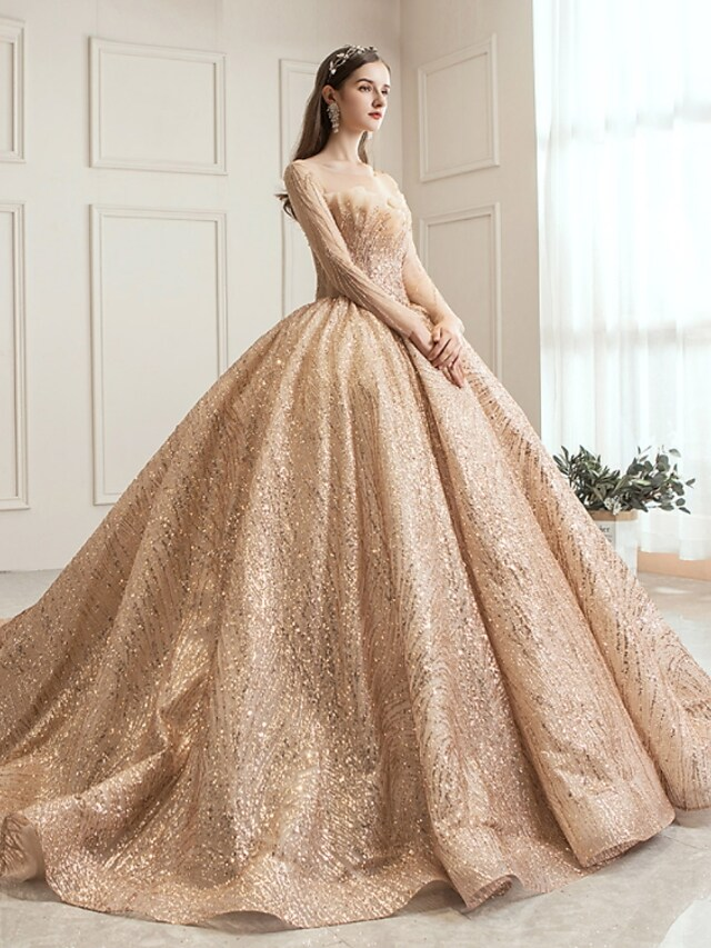 Back view of the elegant sequined tulle wedding ball gown with a flowing chapel train.