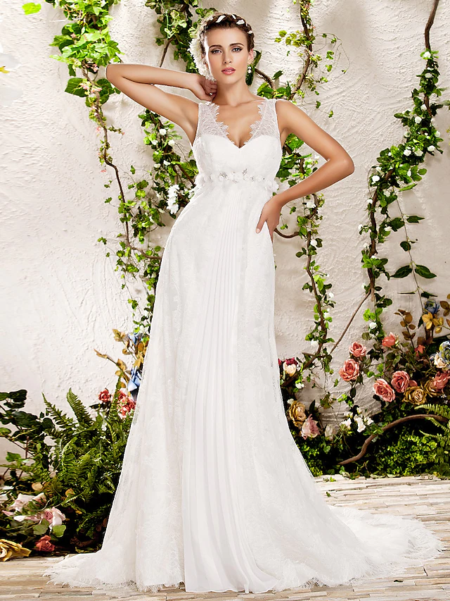 Full view of a bride in a white V-neck sheath lace wedding dress with a chapel train.