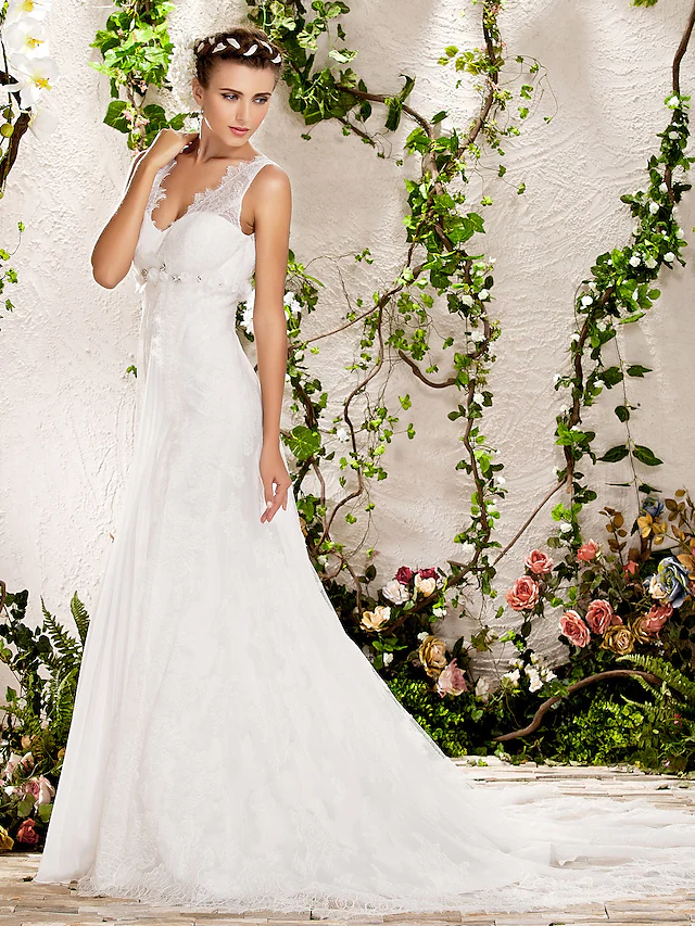 Close-up of the delicate lace detailing on the V-neck wedding dress.