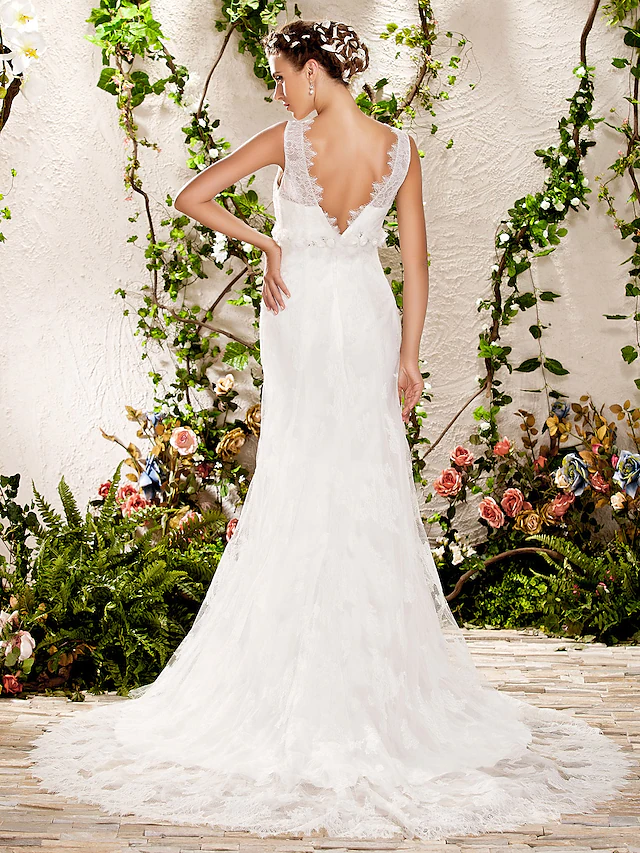 Side view of the bride in the elegant sheath column wedding gown.