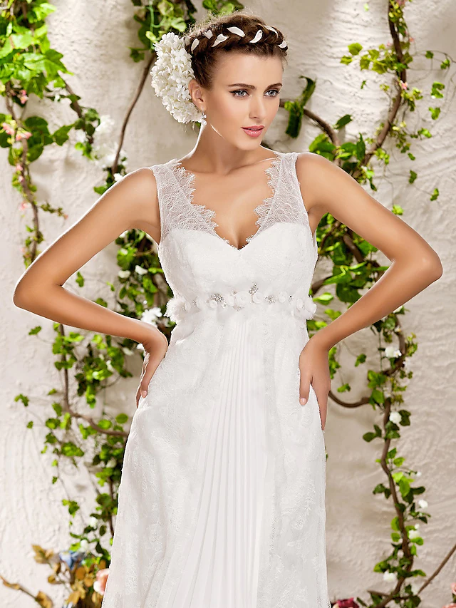 Bride posing gracefully in the sleeveless V-neck wedding dress.
