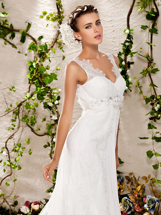 Detailed view of the chapel train and lace hem of the wedding dress.