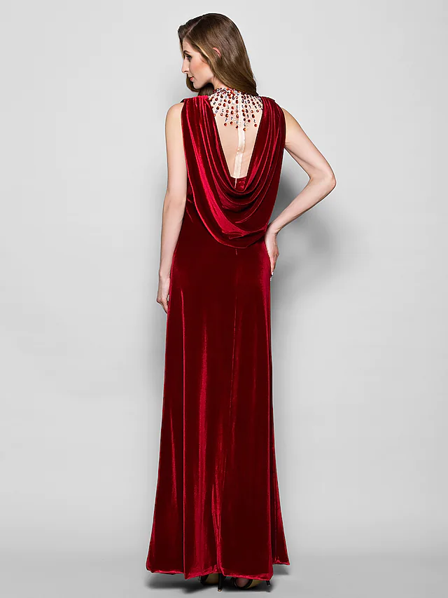 Model in a dark velvet cowl neck gown, showing the back and side profile.