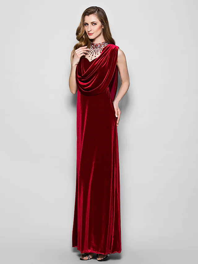 Model posing in the dark velvet floor length dress, showcasing the full silhouette.