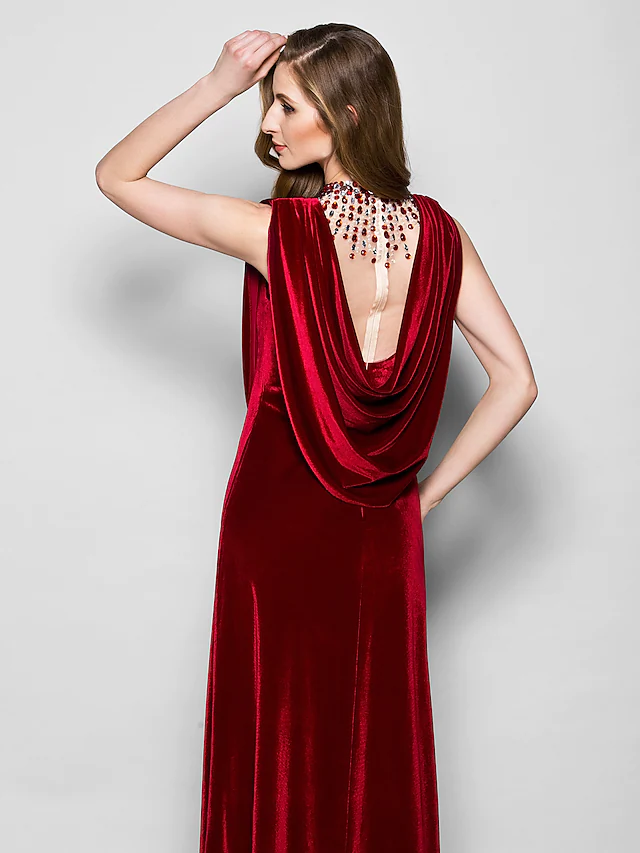 Back view of the dark velvet cowl neck dress, highlighting the floor length.