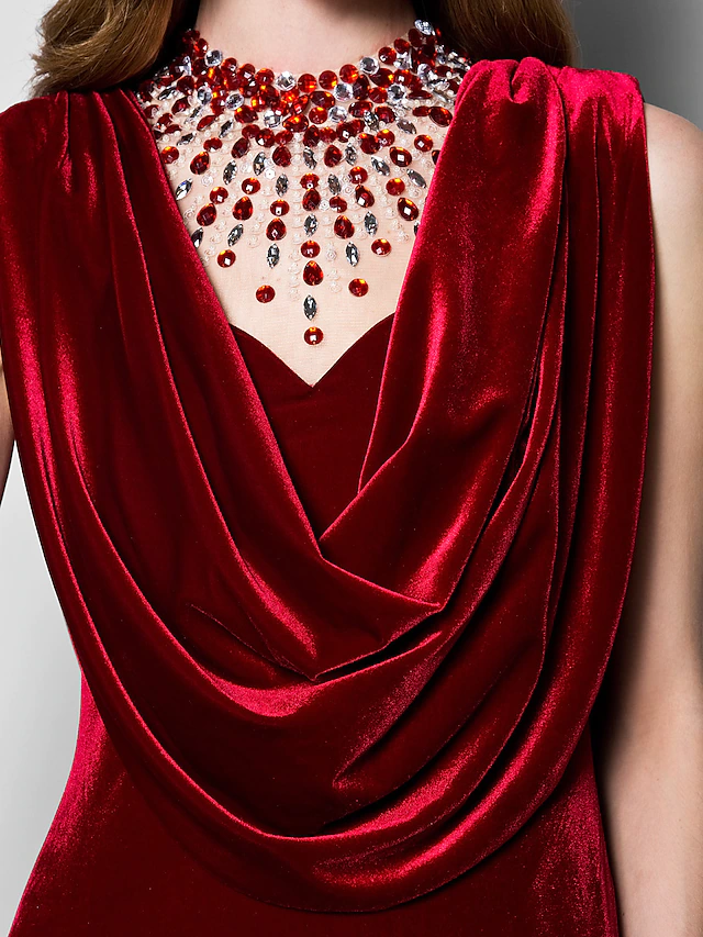 Model in the dark velvet dress, showing movement and drape of the fabric.