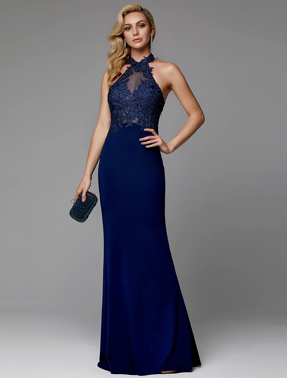 Model wearing an elegant floor-length halter sheath dress with cut-outs and appliques.