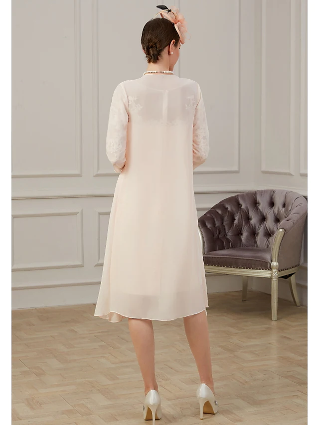 Side view of a woman wearing a dark blue chiffon Mother of the Bride dress.