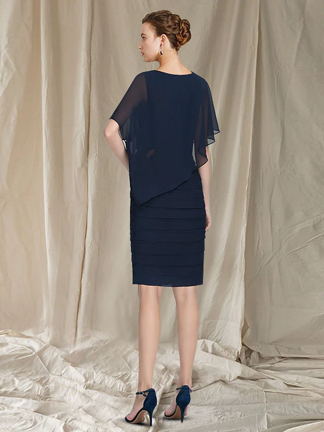 Close-up of ruched and ruffled details on the elegant chiffon dress.