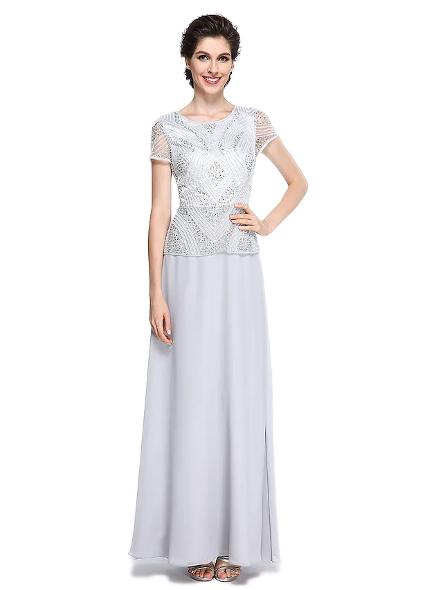 Woman wearing an elegant jewel neck mother of the bride dress with short sleeves, beading, and sequins.