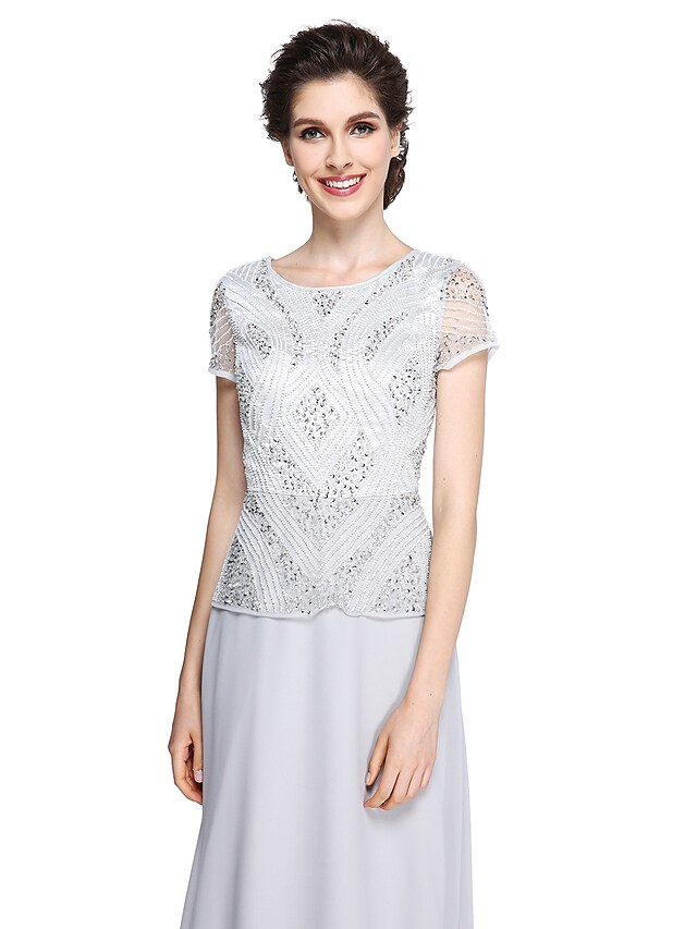Close-up of the jewel neck and short sleeve detail on the chiffon dress.