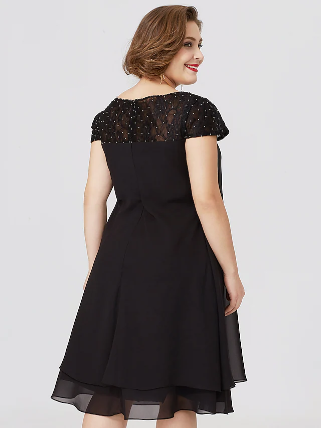 Plus size black Mother of the Bride dress with jewel neck, short sleeves, chiffon lace, pleats, and beading.
