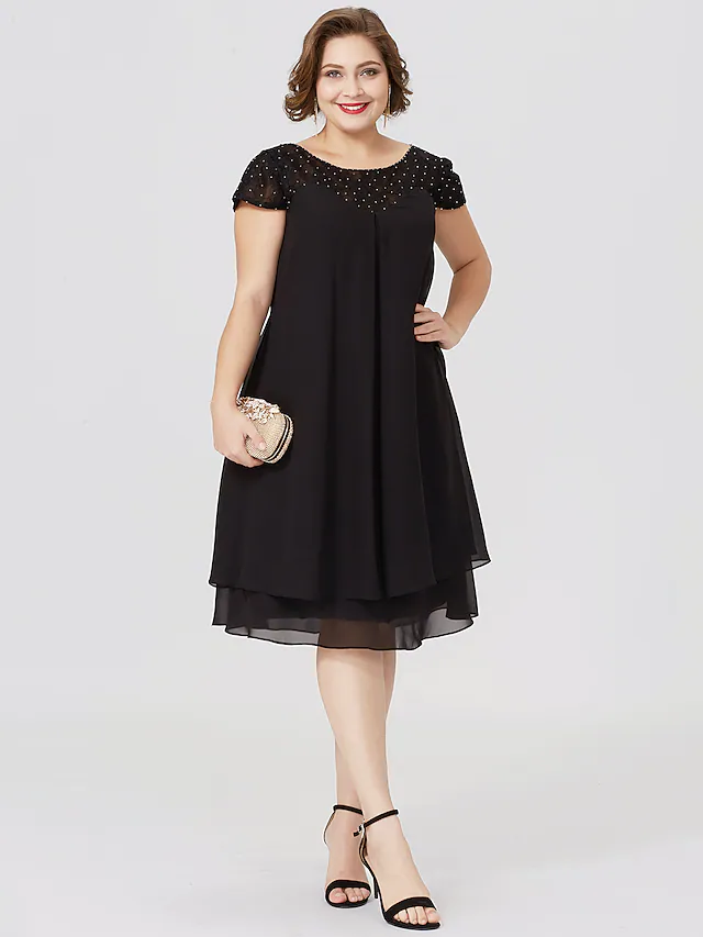 Plus size black Mother of the Bride dress with jewel neck, short sleeves, chiffon lace, pleats, and beading.