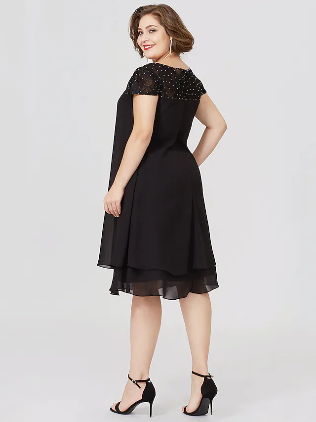 Plus size black Mother of the Bride dress with jewel neck, short sleeves, chiffon lace, pleats, and beading.