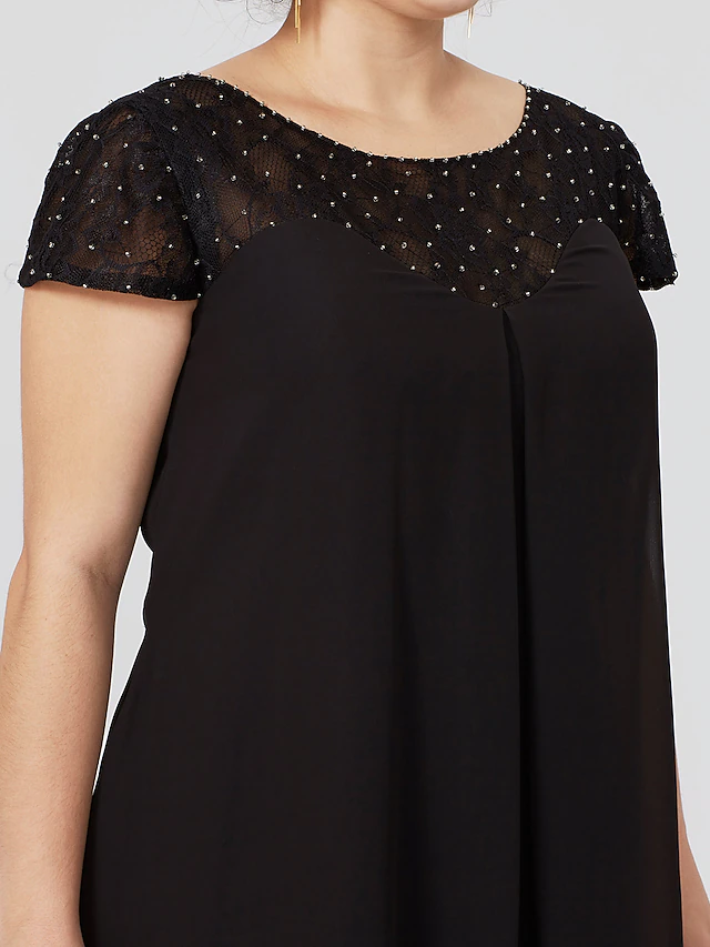 Plus size black Mother of the Bride dress with jewel neck, short sleeves, chiffon lace, pleats, and beading.