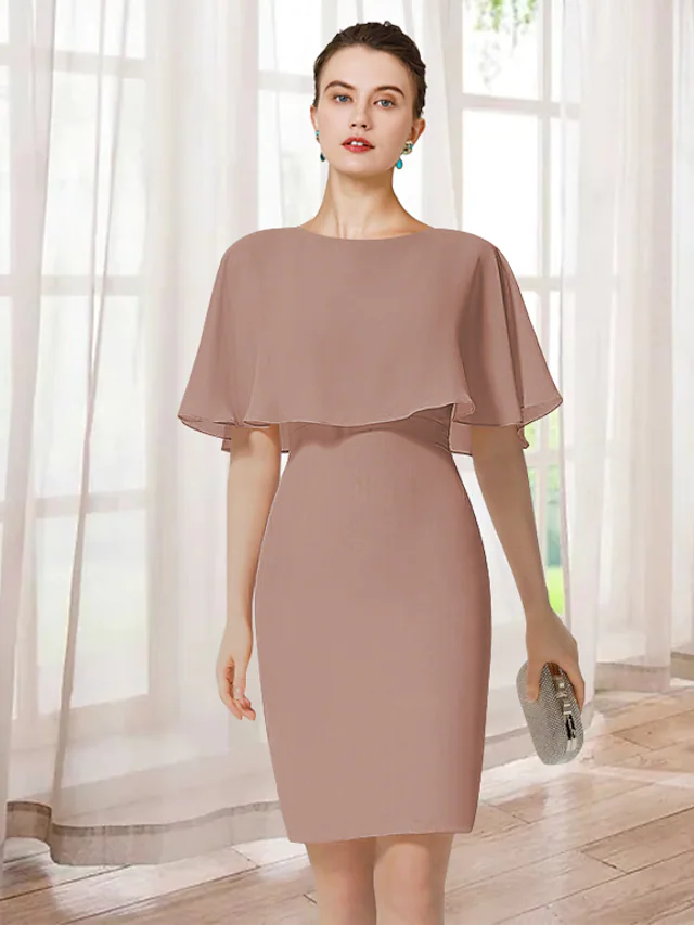 Woman wearing an elegant light blue short chiffon mother of the bride dress with a jewel neck, short sleeves, and ruffles.