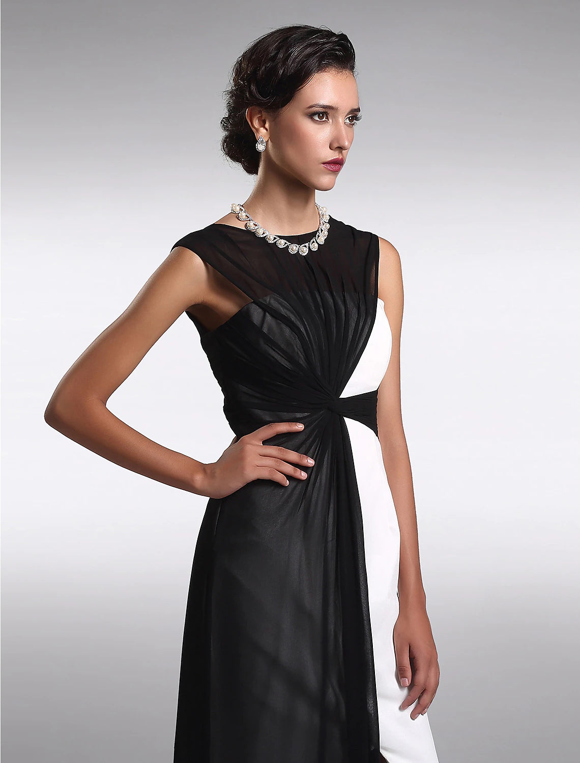Side profile of the floor-length black georgette dress.