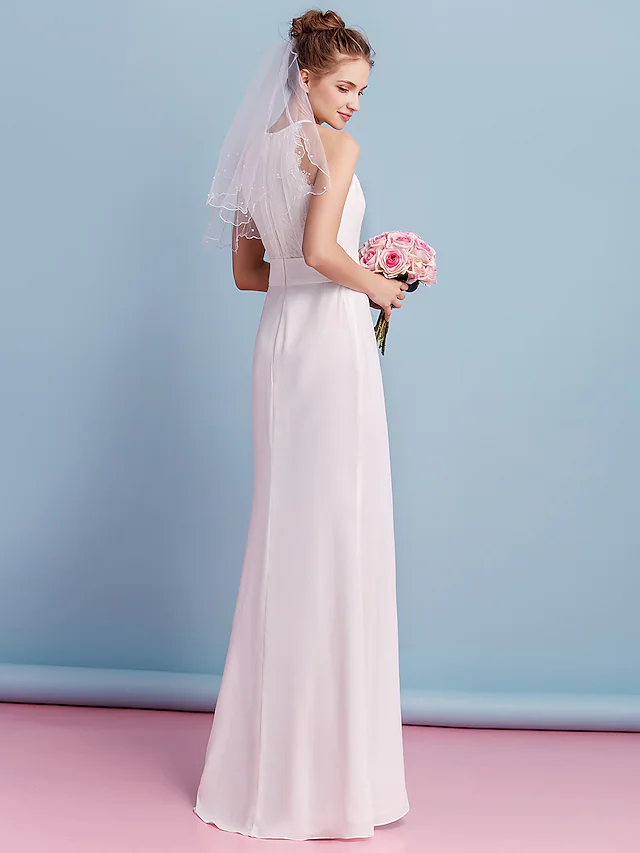 Close-up of the jewel neck and regular straps of the wedding dress, showing lace details.
