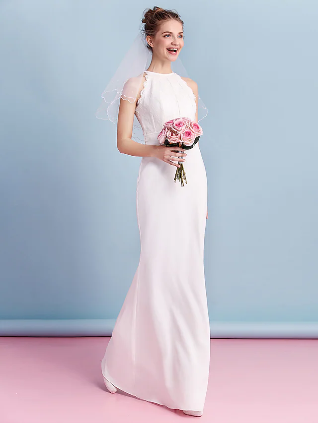 Back view of the floor-length wedding dress, highlighting the lace and chiffon fabric.