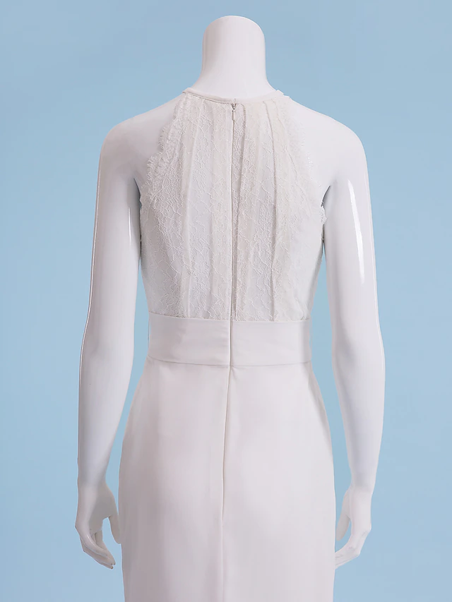 Detail of the floral lace and ribbon sash on the wedding dress.